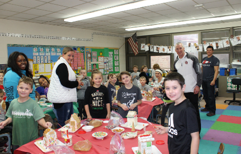 Students with gingerbread houses in class